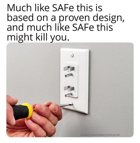 Picture of someone turning a screw on the faceplate of a poeer outlet. Instead of sockets, the outlet has prongs protruding.

Caption: Much like SAFe this is based on a proven design, and much like SAFe this might kill you.