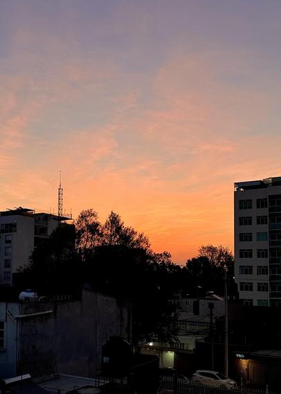 A beautiful orange-violet sunrise against the city’s silhouette