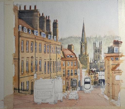 A watercolor painting in progress depicting a street scene with Bath stone buildings, windows, and varying chimney styles. In the background, a tall church steeple and additional architectural features are visible. Some vehicles are sketched along the street, at the moment not painted fully.