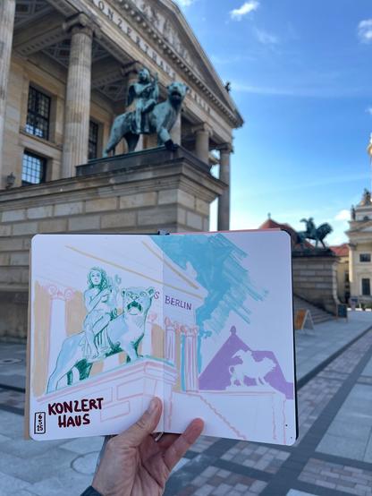 A sketchbook with a sketch of the Konzerthaus Berlin , just in front of it.