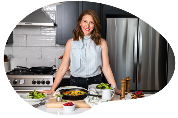 Dr. Casey Means, posing in her kitchen, surrounded by healthy food. 
(Photo from her website)