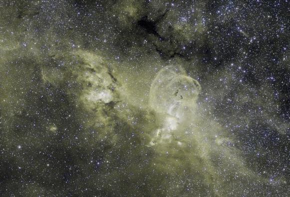 A crop of the center of the bright nebula showing some bright and dark parts that make it look vaguely like the statue of liberty, with some billowing cloud behind it.