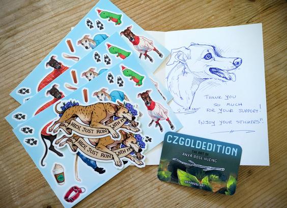Photo of a card with a ballpoint pen drawing of a greyhound dog, and the message "Thank you so much for your support! Enjoy your stickers!" hand written beneath them. On the left is a stack of vinyl stickers: three sticker sheets of greyhounds wearing jackets, and two loose running greyhound stickers with a banner that reads, "Heck, Just Run With It". A business card next to the stack says, "CZGoldEdition", "The Art of Anya Rose Hueing", "anyarose.art".