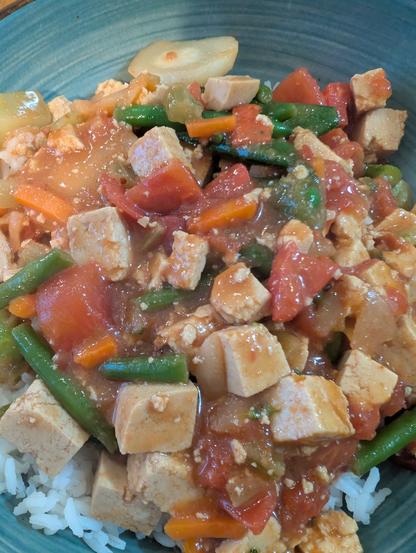 A luscious pile of vegetables and tofu over rice