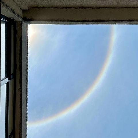 Photo of the sun’s halo, peeking from the corner of a building’s patio