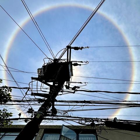 Photo of the sun’s halo behind a utility pole