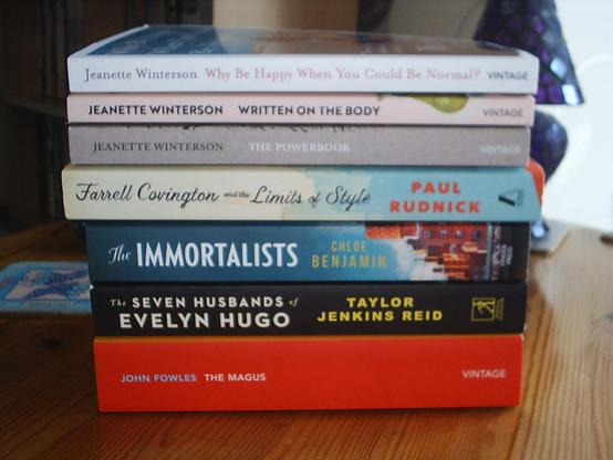 A pile of new books.  From top to bottom:
Why Be Happy When You Could Be Normal? by Jeanette Winterson
Written on the Body by Jeanette Winterson
The Powerbook by Jeanette Winterson
Farrell Covington and the Limits of Style by Paul Rudnick
The Immortalists by Chloe Benjamin
The Seven Husbands of Evelyn Hugo by Taylor Jenkins Reid
The Magus by John Fowles