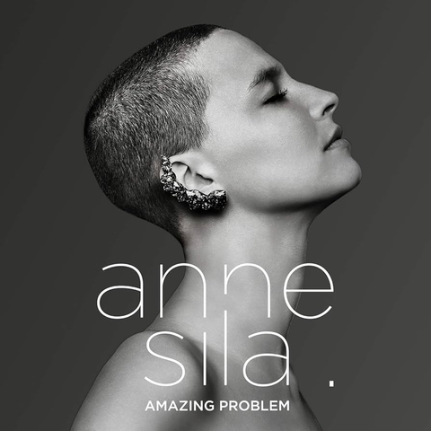 White and black (and grey) album cover of a picture of Anne Sila from the side, eyes closed, with trimmed hair and a big rocky shiny jewel around the shape of her ear.