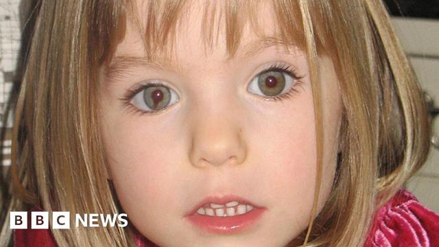 Madeleine McCann stares at the camera. She has blue eyes and dark blonde hair in a bob haircut.