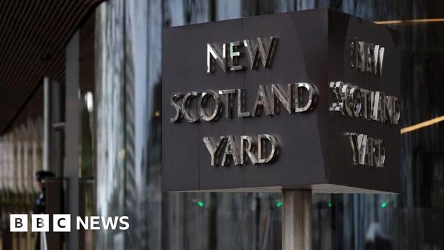A close up of the signpost outside New Scotland Yard in London