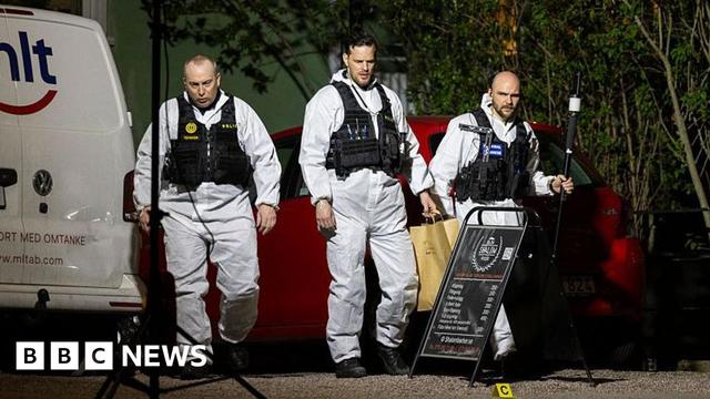 Police forensic officers in white uniforms at the scene of the shooting this week