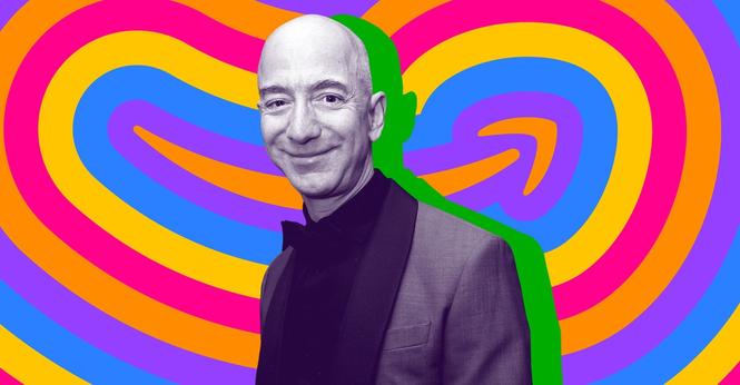 Jeff Bezos stands in front of an Amazon logo